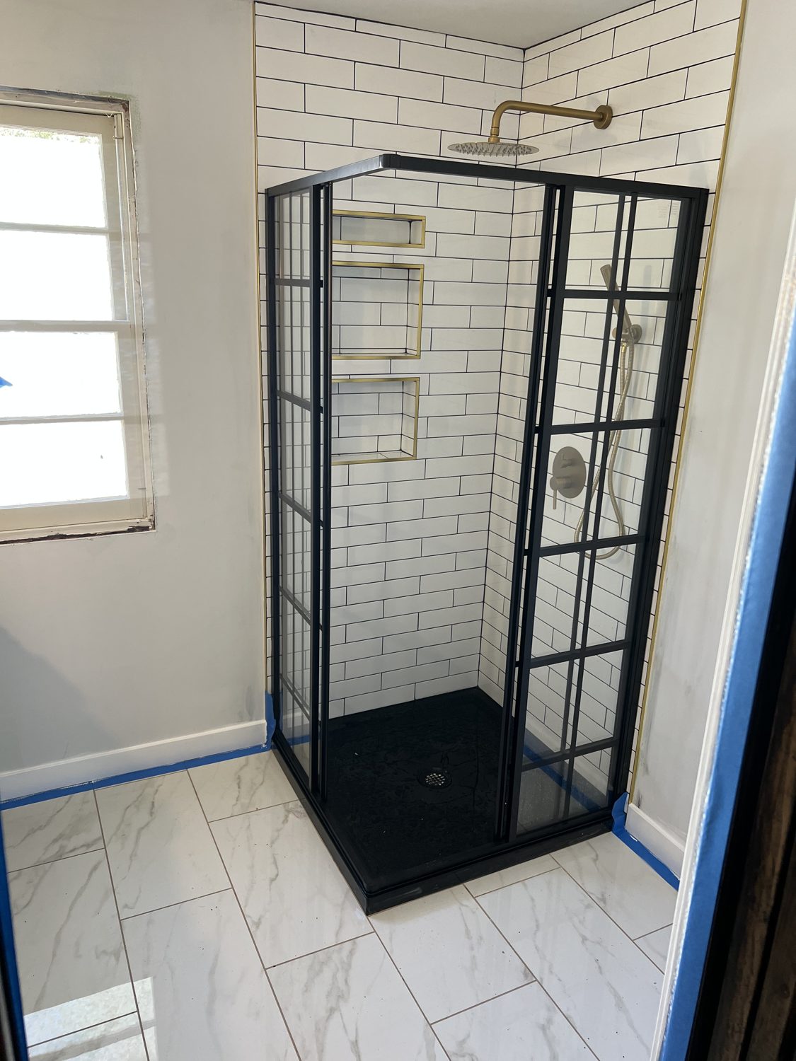 Custom frameless glass walk-in shower with tile in a Kansas City bathroom remodel